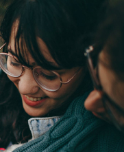 woman being hugged wearing glasses